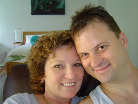 A happy Maurren and me at the CrookNeck Retreat cabin. The bed and part of the spa is in the background.