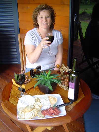 Maureen enjoying the treats at the table on the deck outside the cabin